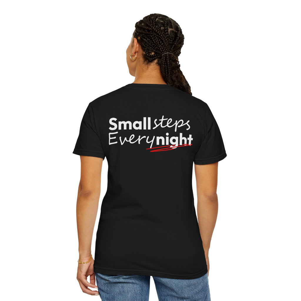 Person wearing a Black t-shirt with 'Small steps Every night' text on a white background