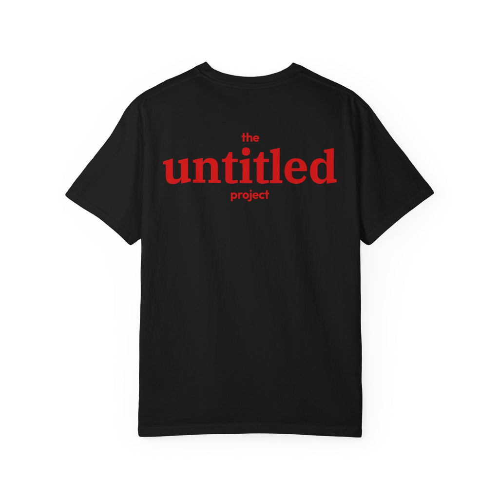 Black comfort color 1717 zeromode t-shirt with "the untitled project" text on the back in red color.