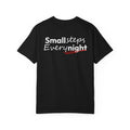 Black t-shirt with 'Small steps Every night' text on a white background