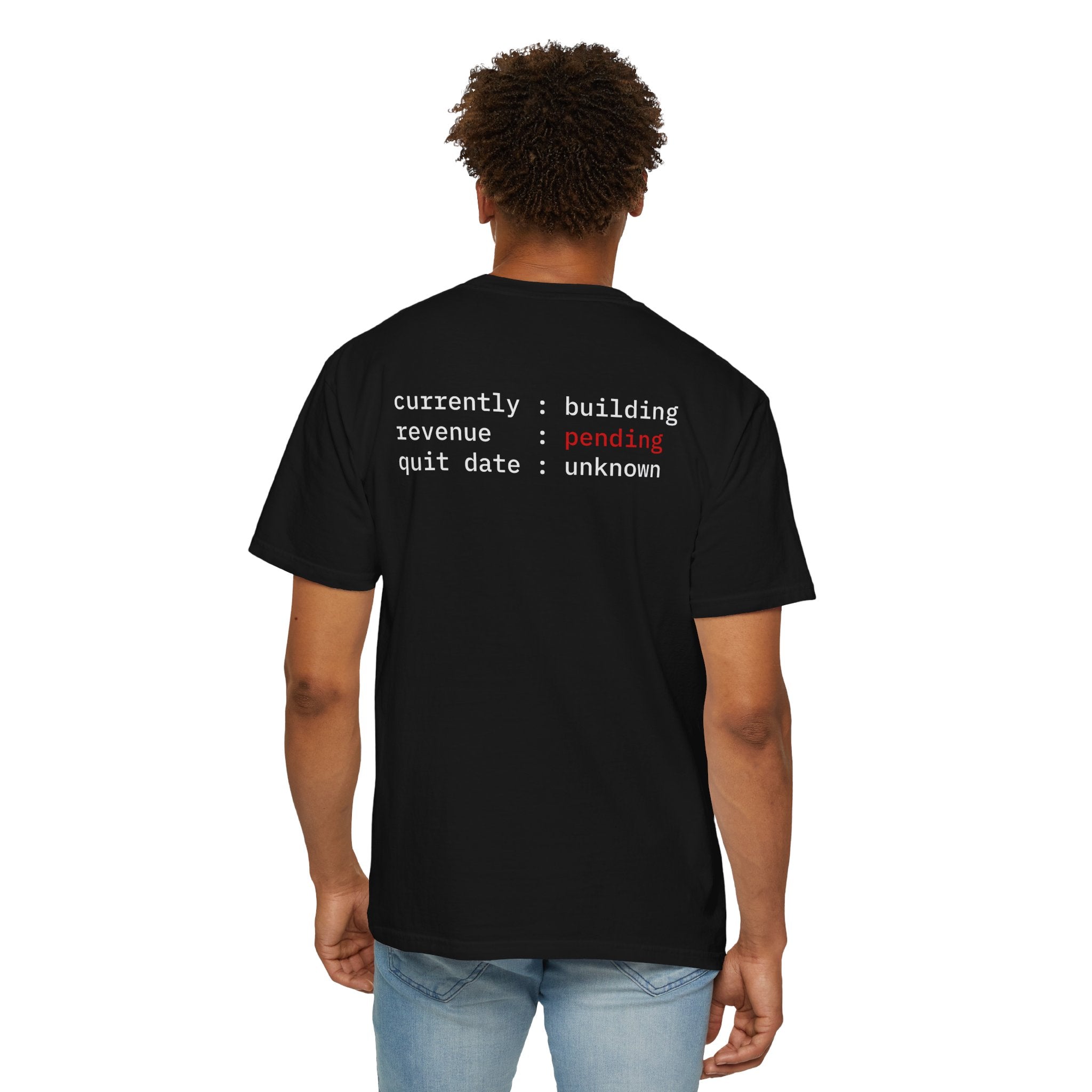Person wearing a Black t-shirt with texts on the back, standing against a white background.