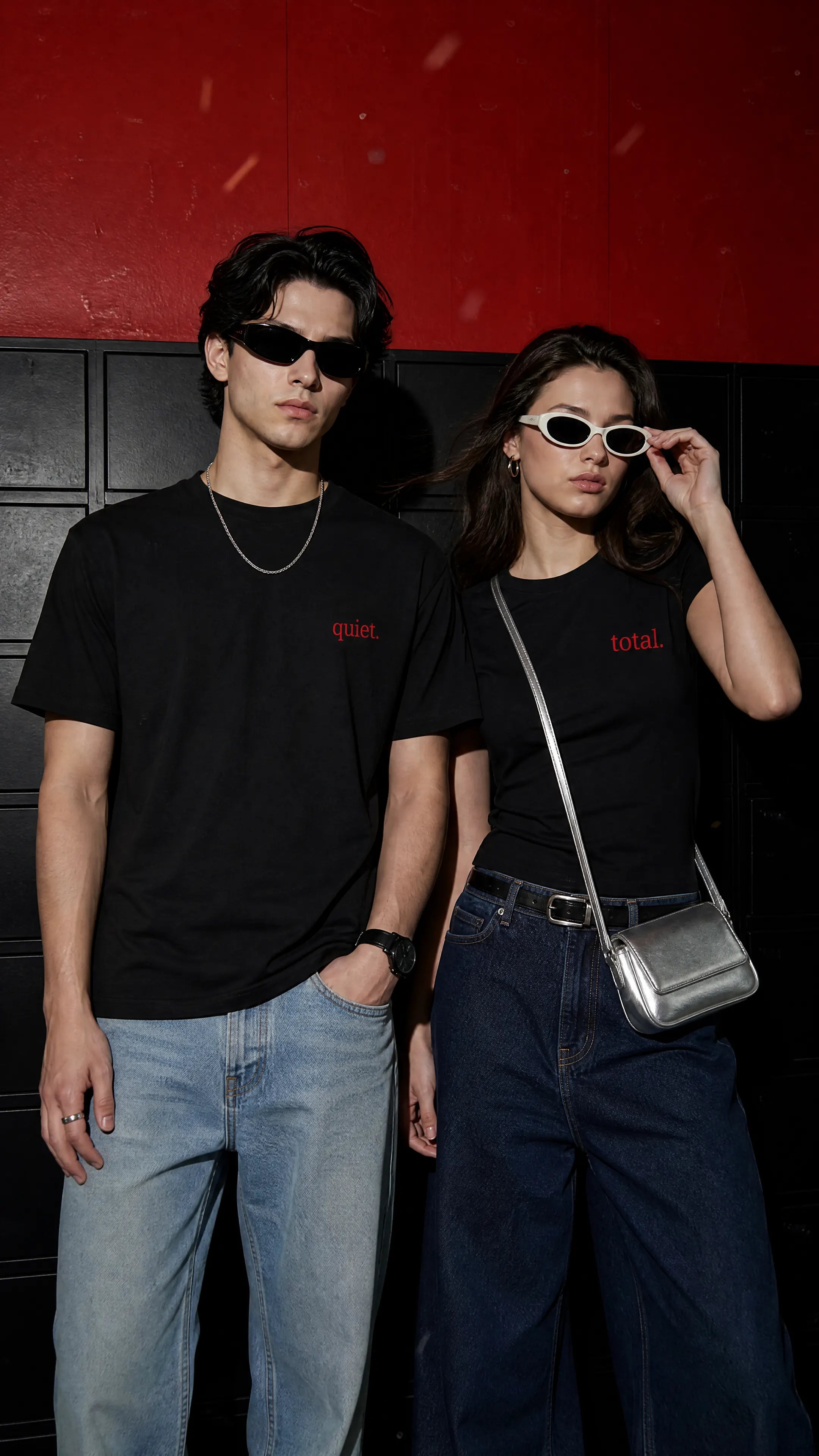 Zehran and Zehra wearing black zeromode t-shirts with red text, standing against a red and black background.