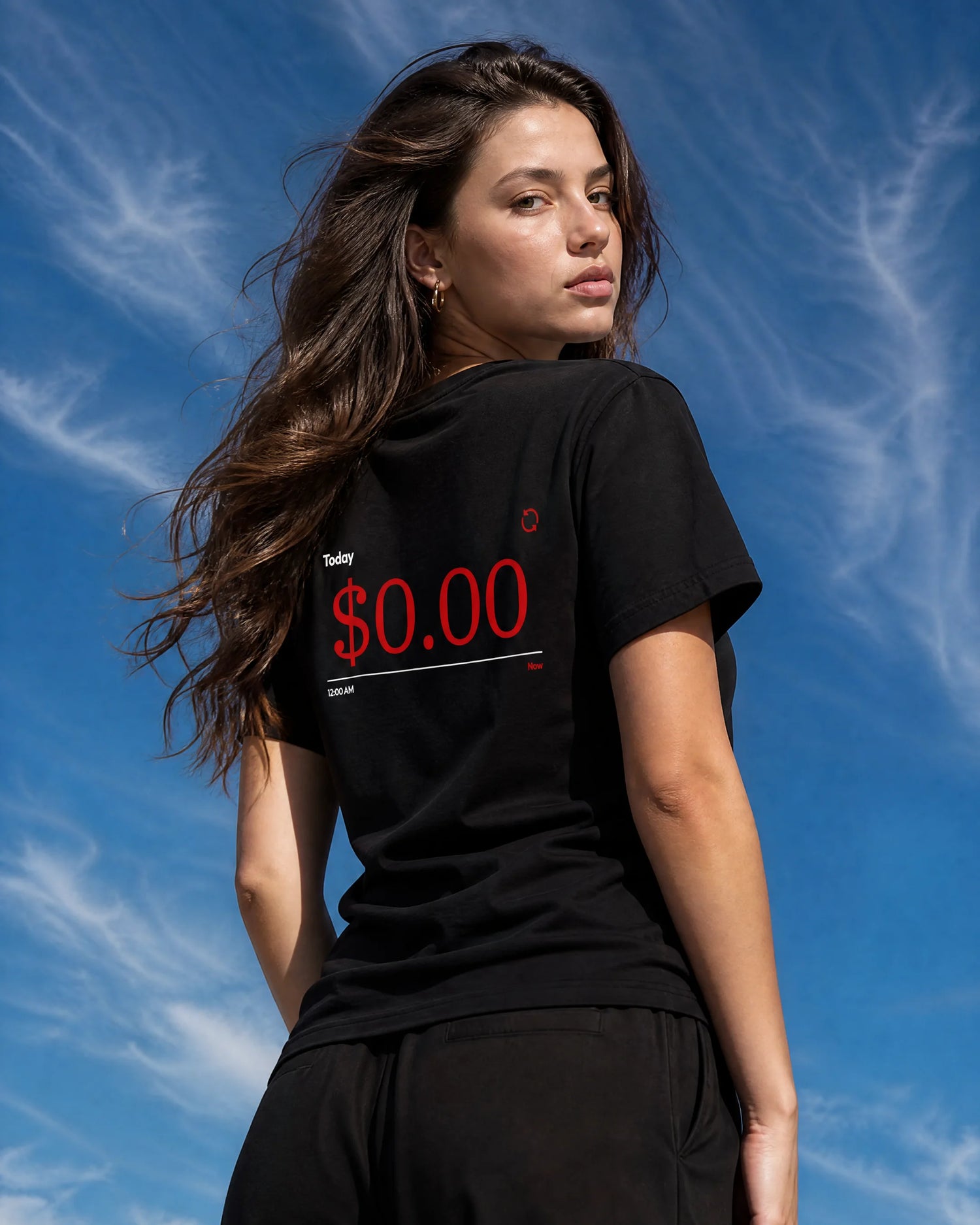 Woman wearing a black t-shirt with red text against a blue sky